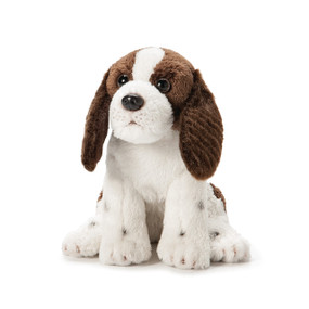 Small white/brown stuffed dog animal sitting up with floppy ears