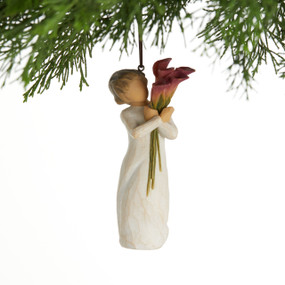 Front view, female figure in cream dress, holding tall bouquet of fuchsia calla lilies. Hook and loop affixed to head