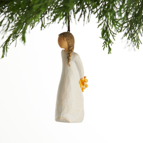 Front view, female figure in cream dress, holding bouquet of orange flowers behind back. Hook and loop affixed to head