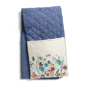 A blue double oven mitt with white fabric ends that have pretty wildflowers on them, displayed folded in half.