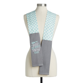A teal and white check fabric kitchen boa with gray towel ends and embroidery that says "Bake the World a Better Place" displayed on a mannequin.