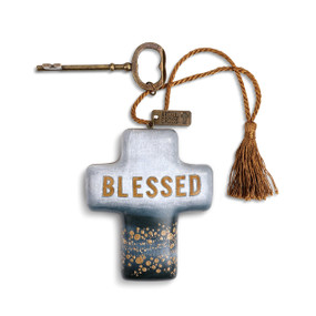 ceramic cross with blue ombre, gold splatters and 'blessed' printed on it tied to a brass key