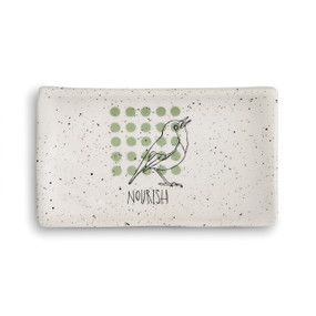 rectangular cream ceramic dish with black speckles and 25 sage dots arranged in a square underneath the black outline of a bird and the word 'nourish'