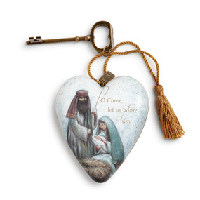 ceramic heart with manger scene and O Come Let us Adore Him printed on it with brass key and hanging string