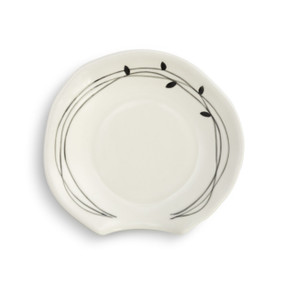 A white spoon rest with a black wreath around the edge.