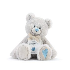 A fluffy white plush bear with a blue nose, blue heart, and a white product tag that reads "Happy December".