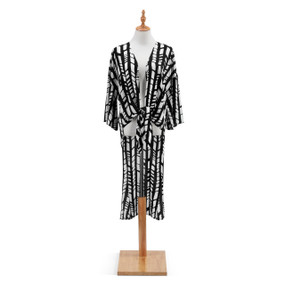 A black and white patterned Tie Front Duster. Placed on a white and black metal mannequin.