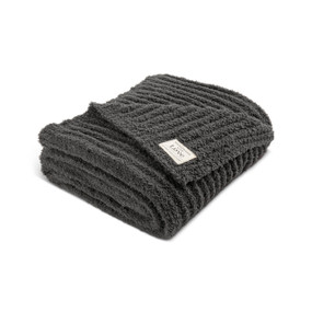 A gray ribbed blanket folded and displayed on a white background. The blanket has a cream Giving Collection fabric patch attached.