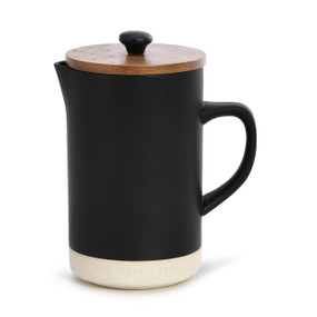 A black and cream french press with a patterned wooden lid.