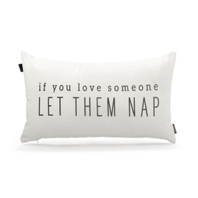 A rectangular white pillow that says "If You Love Someone Let Them Nap" in black.