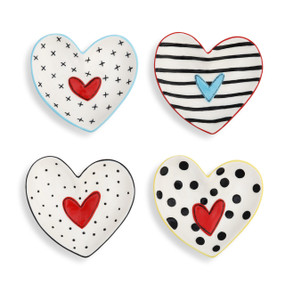 A set of four small heart shaped black and white dish "Treasure Keepers" with various patterns.