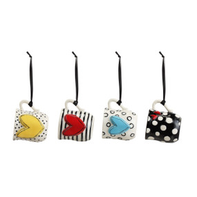 A set of four black and white coffee pod mug ornaments with various patterns.