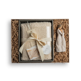 A brown gift box filled with a cream "Giving Shawl" and a Close To Me Willow Tree Angel.