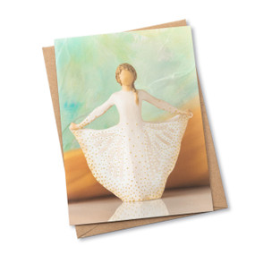 Notecard with image of figure holding gold-dotted cream skirt with both hands. Skirt is carved like Monarch. Blank inside