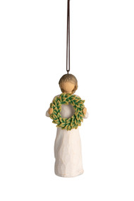 Front view, female figure in cream dress, holding green wreath of magnolia leaves. Hook and loop affixed to figure's head