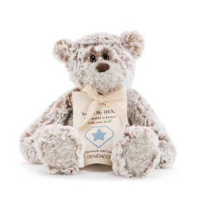 A plush white and brown bear with a sentimental message about heroes.