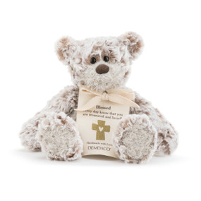 A plush white and brown bear with a sentimental message about Blessed.