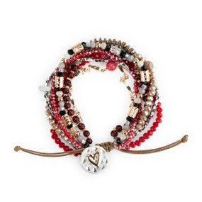 A beaded bracelet set with various gold, silver, black and pink beads and a heart clasp.