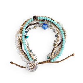 A beaded bracelet set with various turquoise, silver, blue and white beads and a heart clasp.