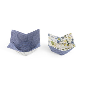 Two blue microwaveable bowl pot holders with various patterns.