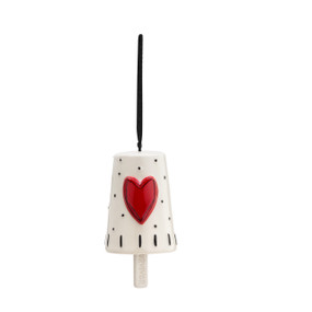 A hanging white Heartful Home Bell" with small black dots and stripes, a red heart in the center, a chime that reads "survivor", and a black ribbon string."