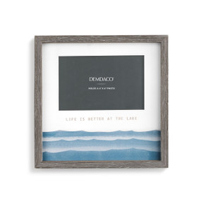 A gray picture frame with a painted blue lake waves scene and "life is better at the lake" engraved.