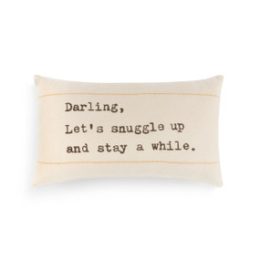A rectangular, cream colored pillow with two yellow stripes, and reads "Darling, let's snuggle up and stay a while."