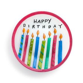 A circular glass platter with a pink rim, and filled with 8 lit, patterned candles and reads "Happy Birthday".
