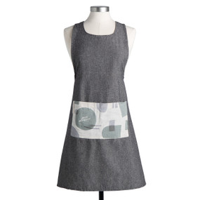 A dark gray apron with a white fabric pocket on the front that says "bon appetit" and has geometric shapes, displayed on a mannequin.
