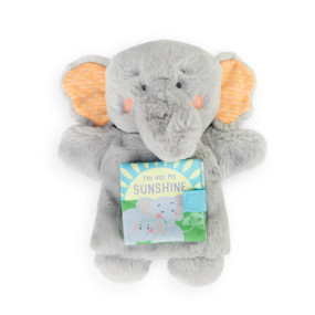 A plush, soft gray elephant puppet book with two large orange ears, and a small blue and green book called You are my Sunshine" on its stomach."