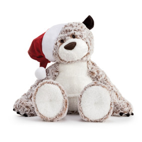 A front facing view of a soft brown and beige plush Holiday Giving Bear, wearing a white and red velvet Santa hat.