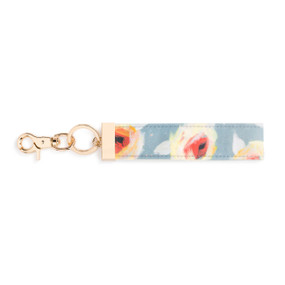 A blue, yellow, and red floral print wrist strap with gold metal accents.