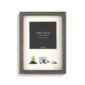 A gray wooden picture frame with an ivory backing, and a pebble scene of a car at a road sign. Filled a gray and white product slip.