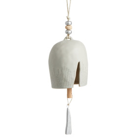 A cream Inspired Bell" with a single crack, small gray font coming from the bottom edge, a twine rope, and silver and wooden beads."