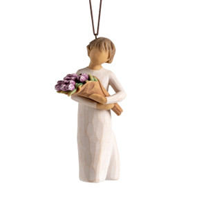 Front view: female figure with brown hair in cream dress holding bouquet of purple tulips; hook and loop affixed to head