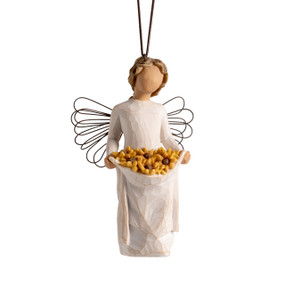 Front view: female figure with wire wings, holding skirt filled with yellow sunflowers; hook and loop affixed to head