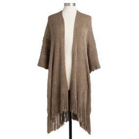 A light brown wrap, textured with small lined pom poms, and a fringed bottom edge. Placed on a black and white mannequin.