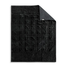 A black velvet throw blanket laid out flat on a white background with one corner turned over.