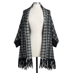 The front view of a black and white fringed shawl displayed on a mannequin.