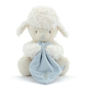 A plush, white sitting lamb with a simple blue heart on its paw. Holding a soft blue blanket with a silver cross.