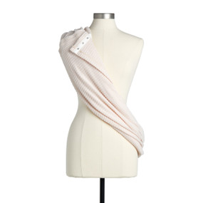 A blush colored scarf with snaps displayed on an angle over a mannequin.