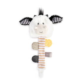 A front view of a white cow plush head with black and white ears attached to a brown and white striped fabric ribbon with four sensory tabs and a white clip at the end.