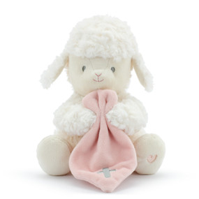 A plush, white sitting lamb with a simple pink heart on its paw. Holding a soft pink blanket with a silver cross.
