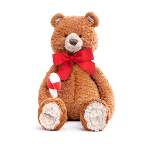 A front facing view of a burnt orange, soft, plush bear with white ears and paws, a red bow, and holding a plush candy cane.
