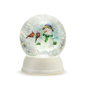 An illuminated snow globe with a white base, and filled with a painting of a snowman holding two cardinals, and glitter crystals.