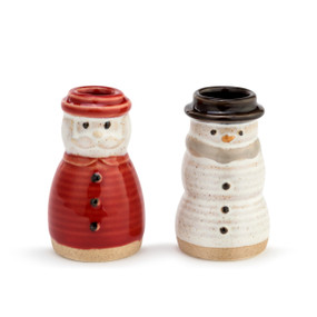 A winter themed salt and pepper shaker set. A textured red Santa shaker, placed to the left of a textured white snowman shaker with a black top hat.