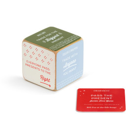 A jumbo wooden dice with different colored sides, each with a "Pass the present" task, such as "Everyone pass presents to the right". Placed beside a red product card.