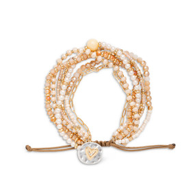An adjustable bracelet made of multiple stands of various beads all in a champagne color and a mixed metal charm with a gold heart.