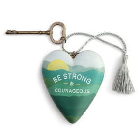 Heart shaped sculpture with a silver tassel and metal key attached. The heart has a green mountain scene and says "Be Strong & Courageous".