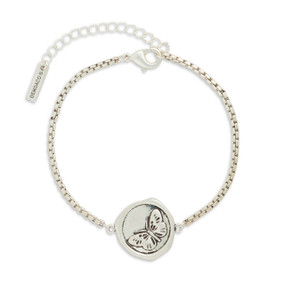 A silver metal bracelet that has a round metal charm with a butterfly image.